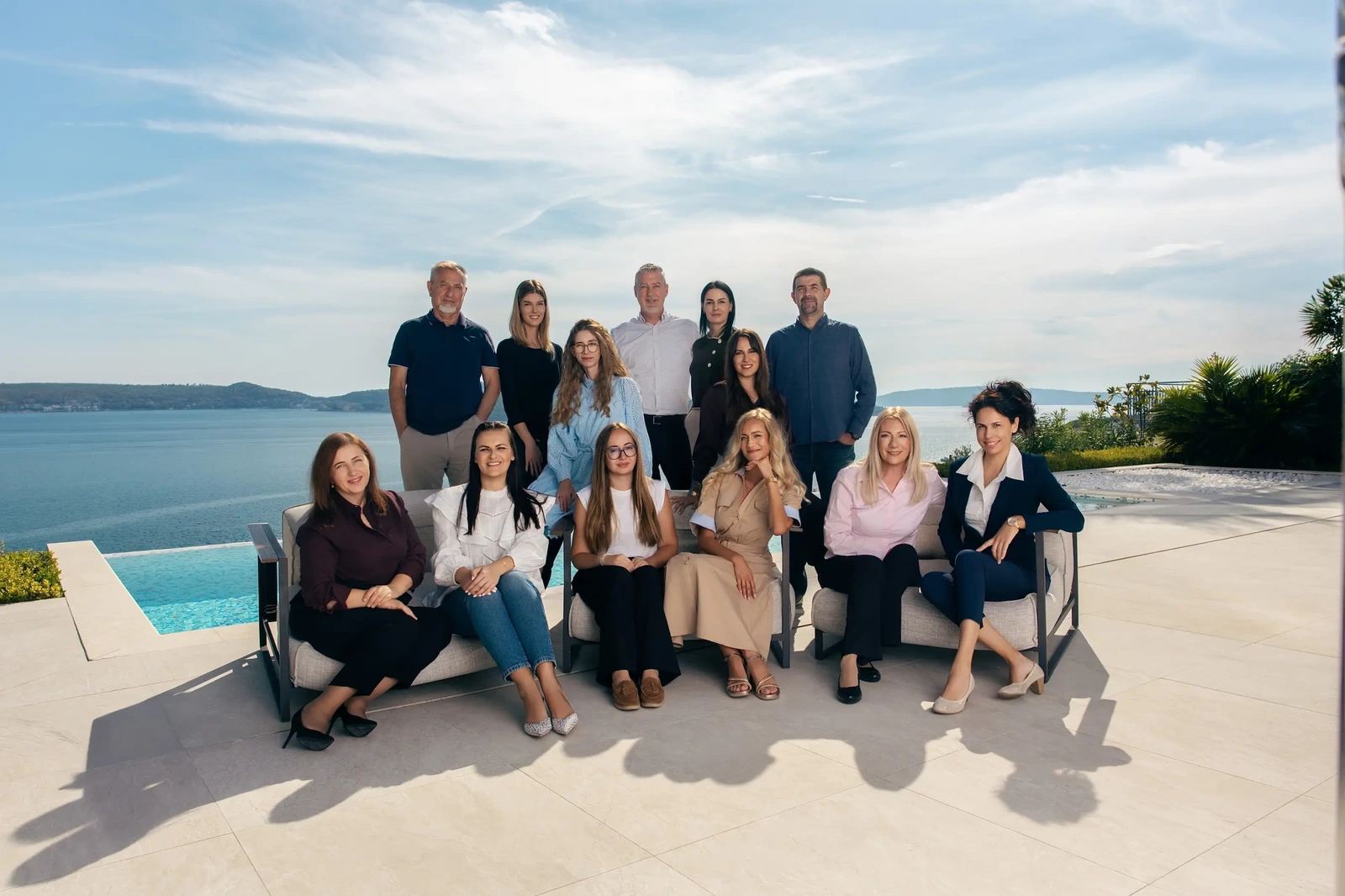 The VIP Holiday Booker team gathered on a terrace overlooking the coast